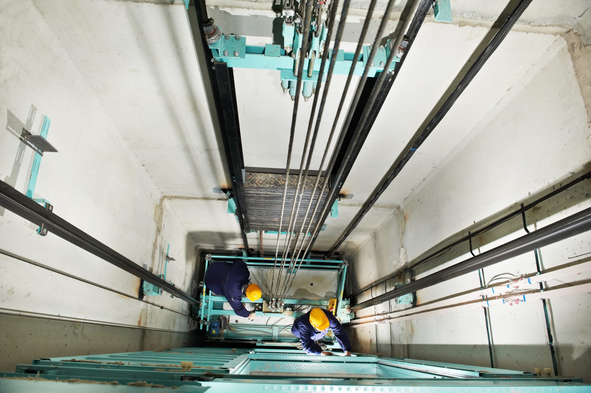 Technicians at Work Adjusting Elevator